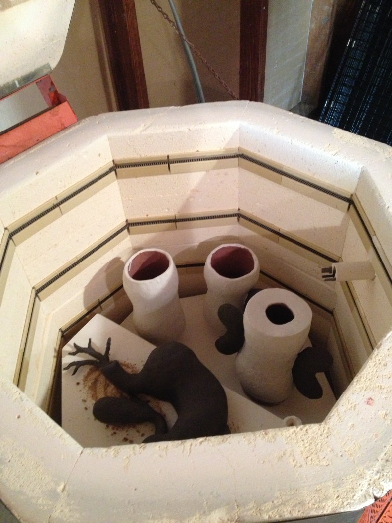 The pieces going back in the kiln after having been coated in glaze---not the doughnut kind silly