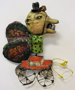 I love this little guy.  He is a wall piece made from clay, paper mache, nichrome wire, acrylic paint, glaze and underglaze.  I hope he's having a good time in his new home. 