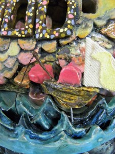 here is a tiny fisherman braving the waters that surround the gaggle bus.  his little canvas sail has an image of a gosling 